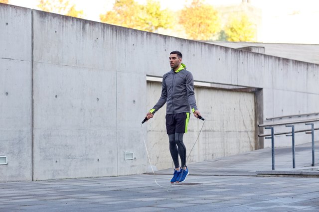 man exercising with jump-rope outdoors