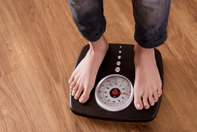 Girl standing on weight