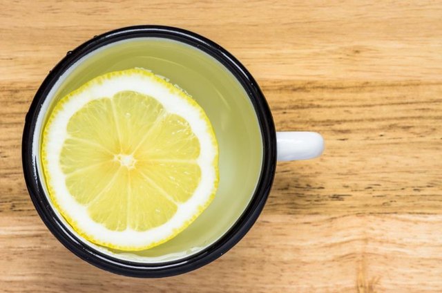 Water with lemon in a steel mug top view