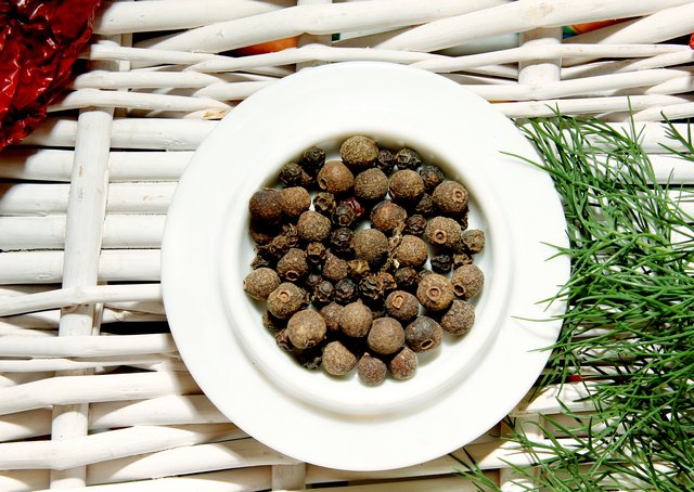 black pepper spices in the center on the background
