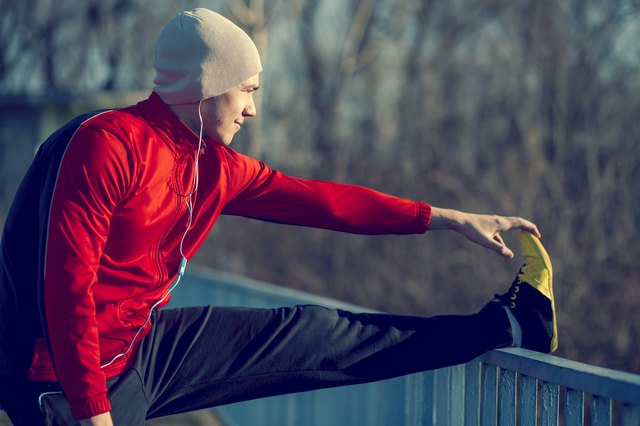 Man stretching legs before running