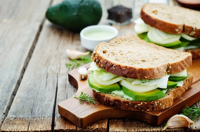 sandwiches with avocado, cheese, cabbage and cheese and herb topping