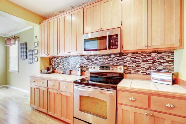 Light wood cabinets with multicolored backsplash