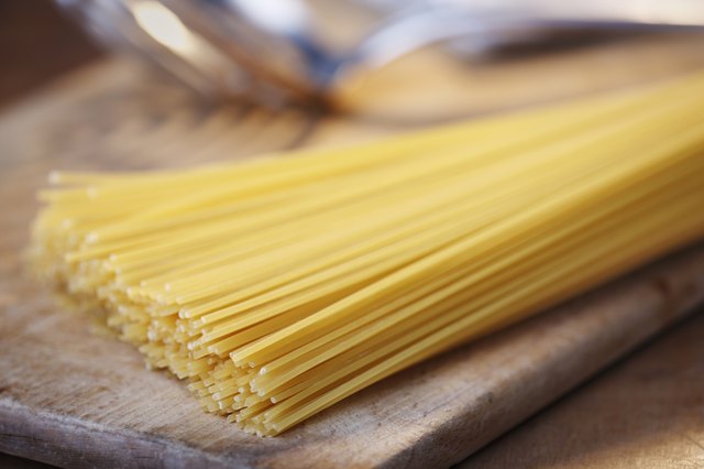 Spaghetti on chopping board, close-up