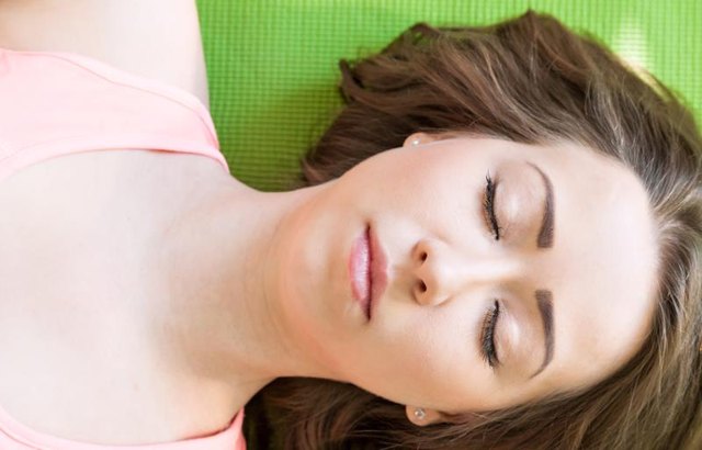 Portrait of a young girl. asana Savasana. Yoga for relaxation. Healthy lifestyle