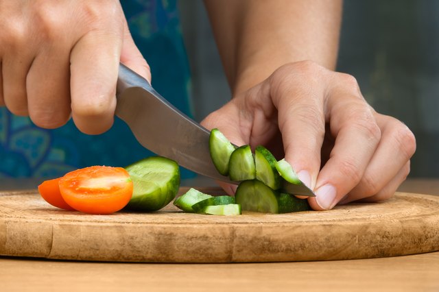 process preparation salad from tomatoes and cucumbers
