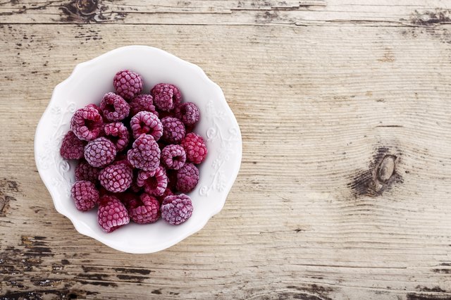 Frozen Raspberry on Wooden background