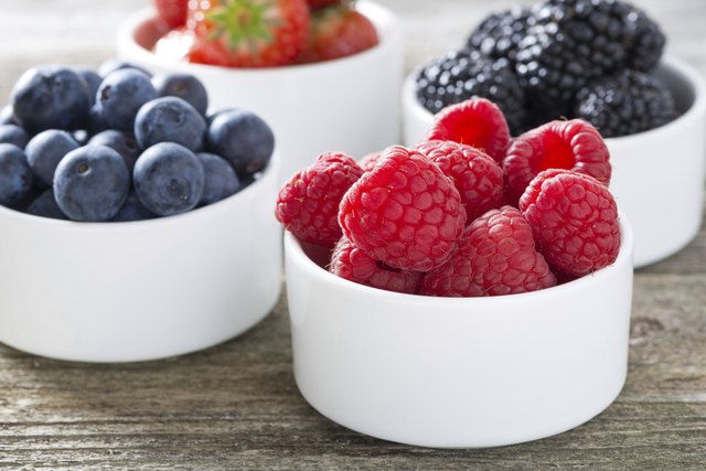 fresh raspberries in a bowl and berries, closeup, horizontal