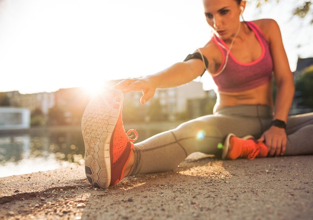 Runner athlete stretching legs