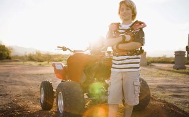 Boy next to ATV