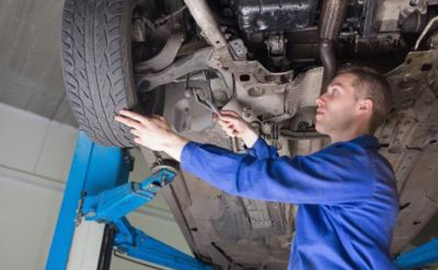 Mechanic inspecting ball joints