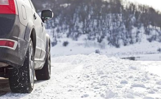 Car driving on snow covered road