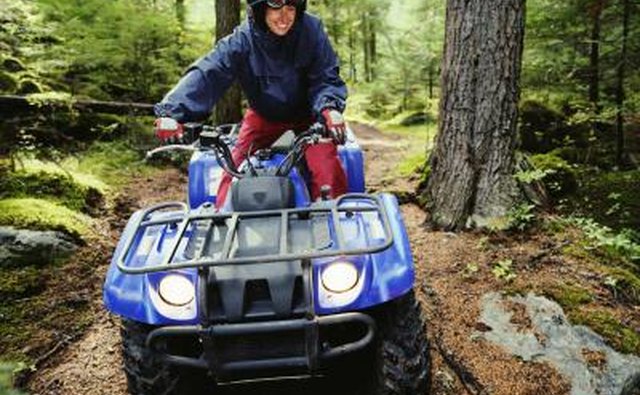 Man driving ATV in woods