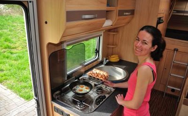 Class C motorhomes often offer an overhead sleeping area, which gives extra room for a living area with kitchen.