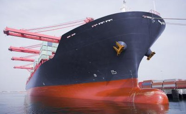 The bow of a large cargo ship in port.