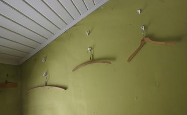 Apply repositionable hooks to your camper wall.