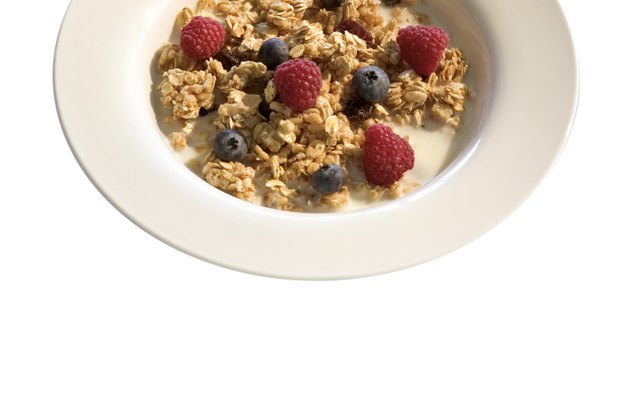 A bowl of cereal with berries forms the foundation for a nutritious breakfast.