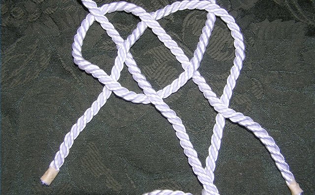Left hand rope threaded through loop on right hand rope