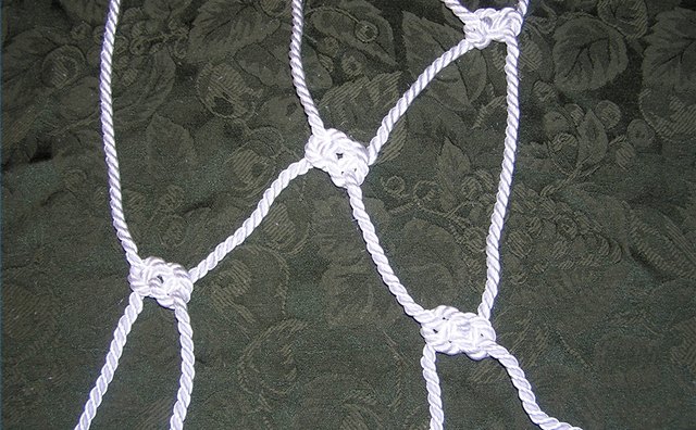 Working the end ropes back into the net