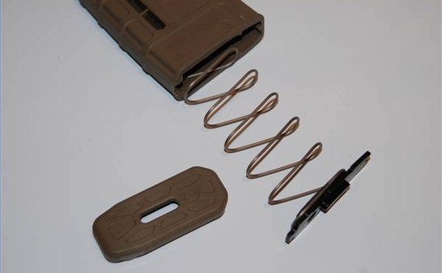 Magazine spring, lock plate and floorplate