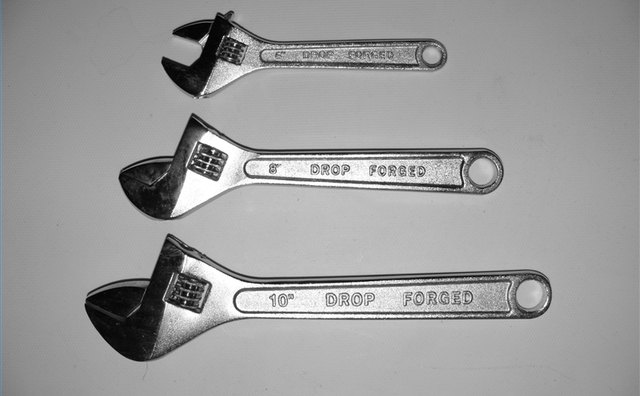 An adjustable wrench or socket wrench will work