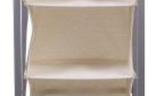 Hang canvas shelves to store folded clothes.