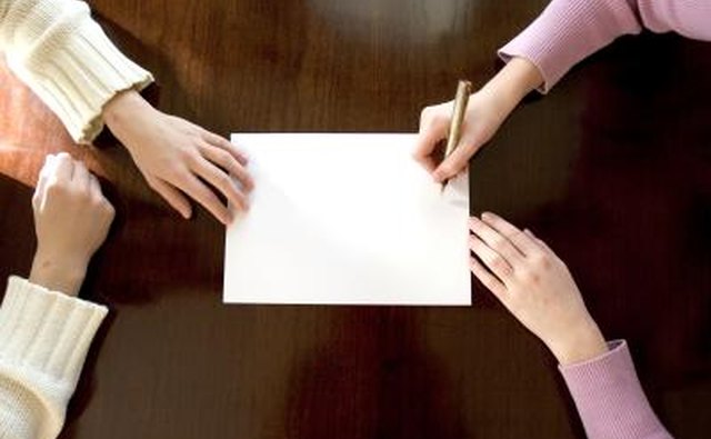 Couple signing form together.