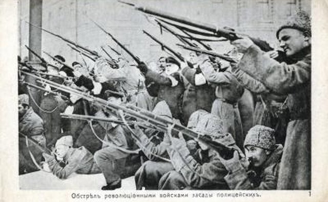The men in this image hold Mosin-Nagant rifles, which fire 7.62x54mm ammunition.