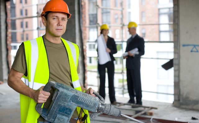 Construction worker holding industrial power tool