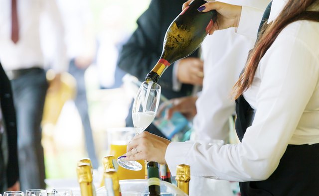 Waiter pouring champagne
