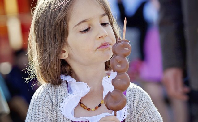 Young girl having a treat at a fair.
