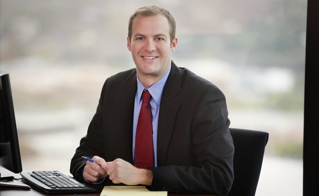 Business Man Sitting In Front Of Computer