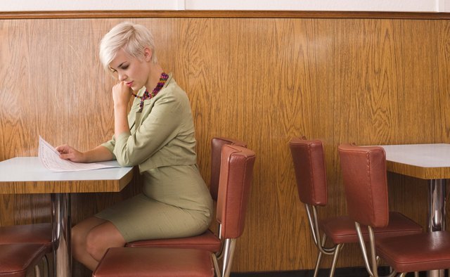Woman reading menu in cafe