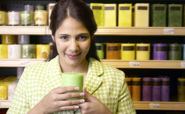 Woman holding a candle in a store