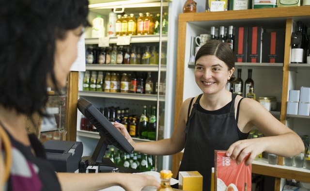 Cashier checking out customer at grocery store