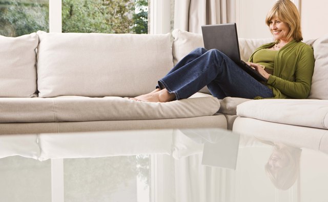 Woman reclining with laptop computer