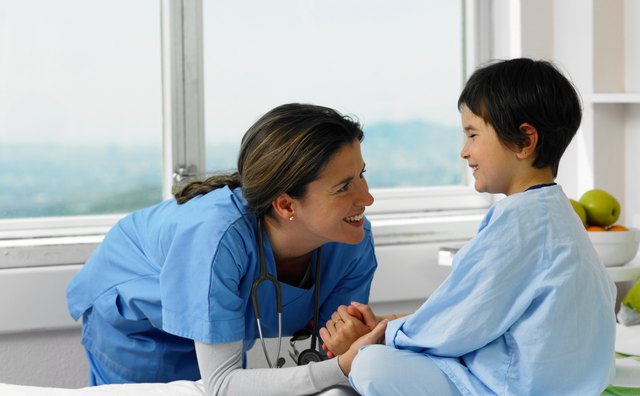 Doctor smiling with patient in hospital bed