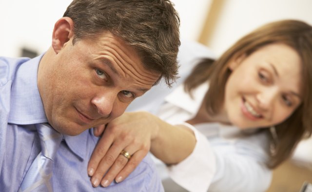 Woman touching businessman on shoulder