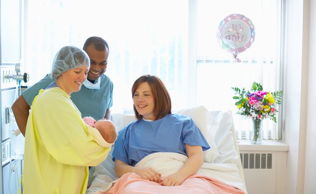 Nurse holding newborn baby