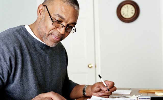 Mature man doing finances in home office