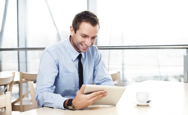 Businessman with digital tablet smiling