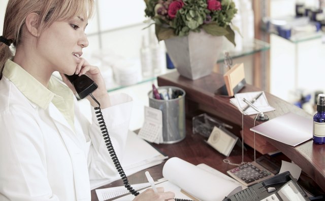 Hairdresser taking an appointment over the phone