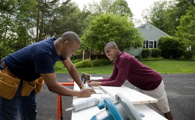 Father and son working on house