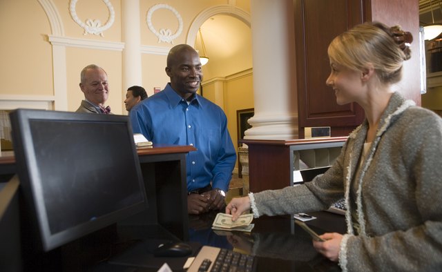 Man waiting in line for bank teller