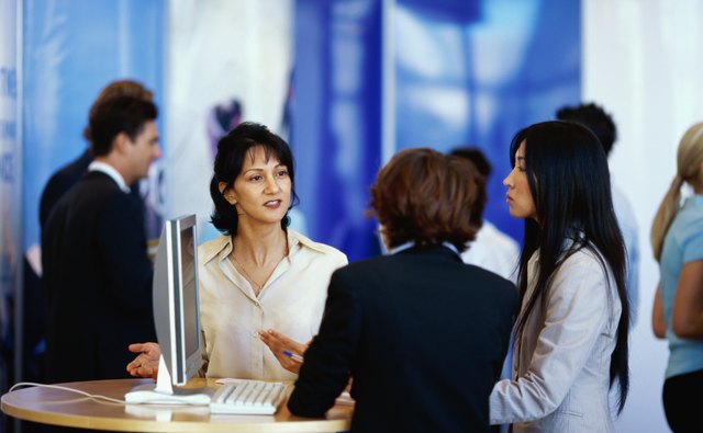 three businesswomen discussing at an exhibition
