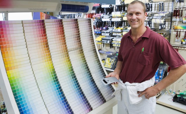 Man in hardware store with paint samples