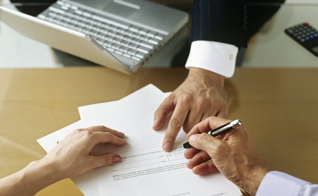 Businessman and couple signing documents,close-up of hands