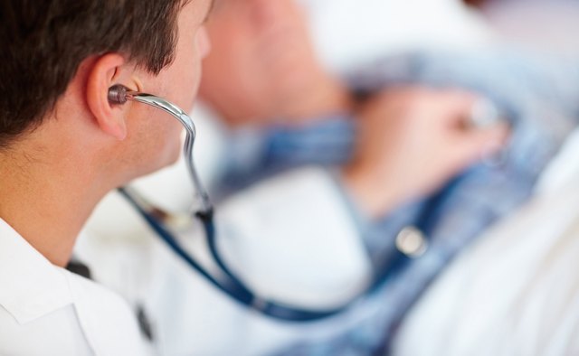 Doctor examining a patients heart beat with a stethoscope