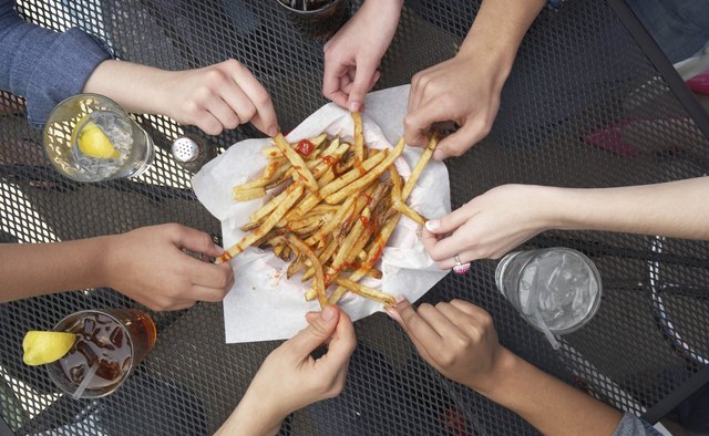 People Sharing French Fries