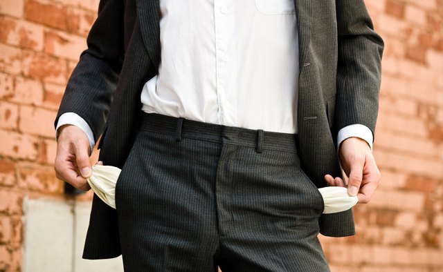 Man outdoors pulling out empty pockets